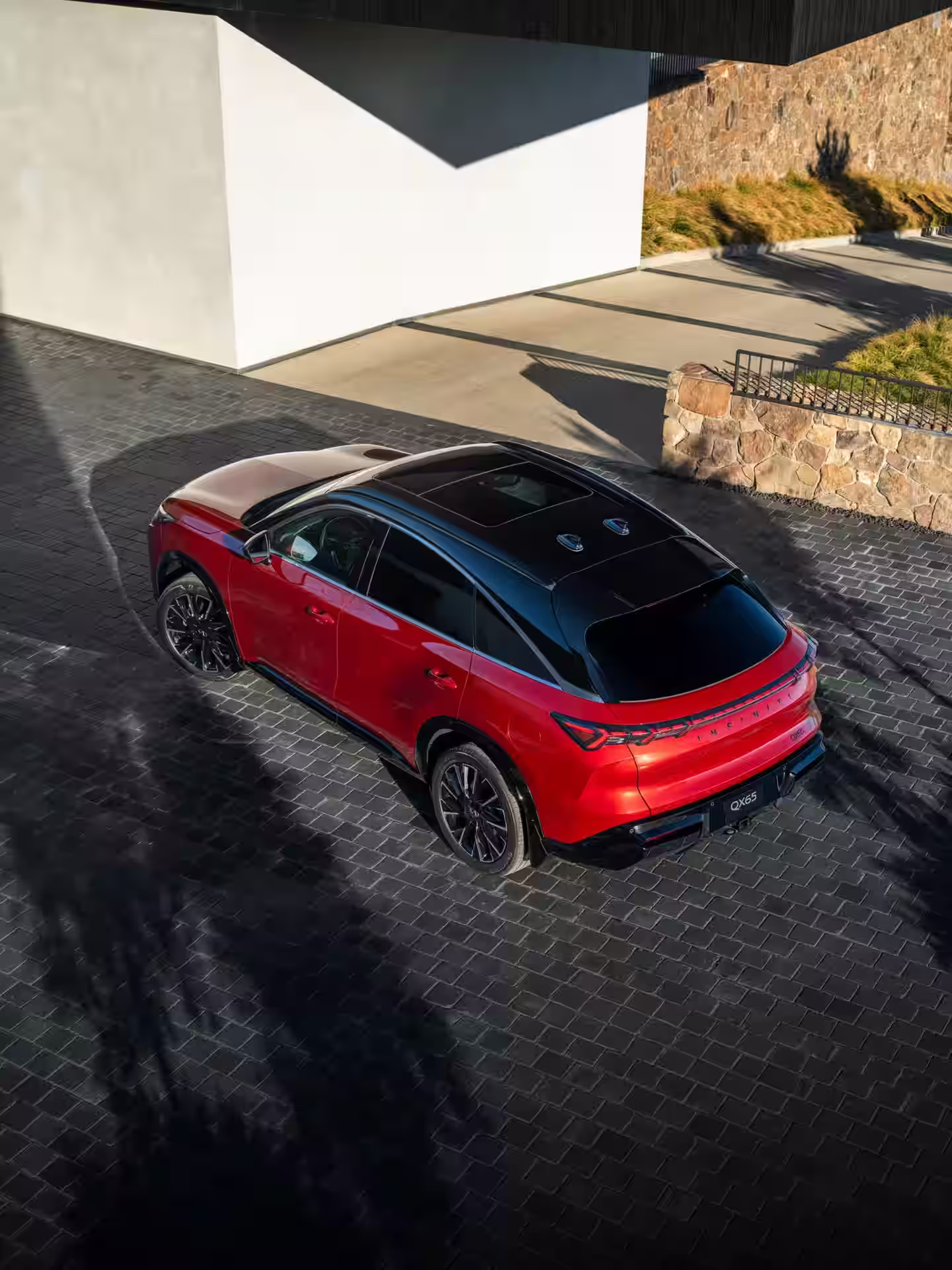 2027 INFINITI QX65 - Sleek Red Coupe SUV Rear With Black Panoramic Roof