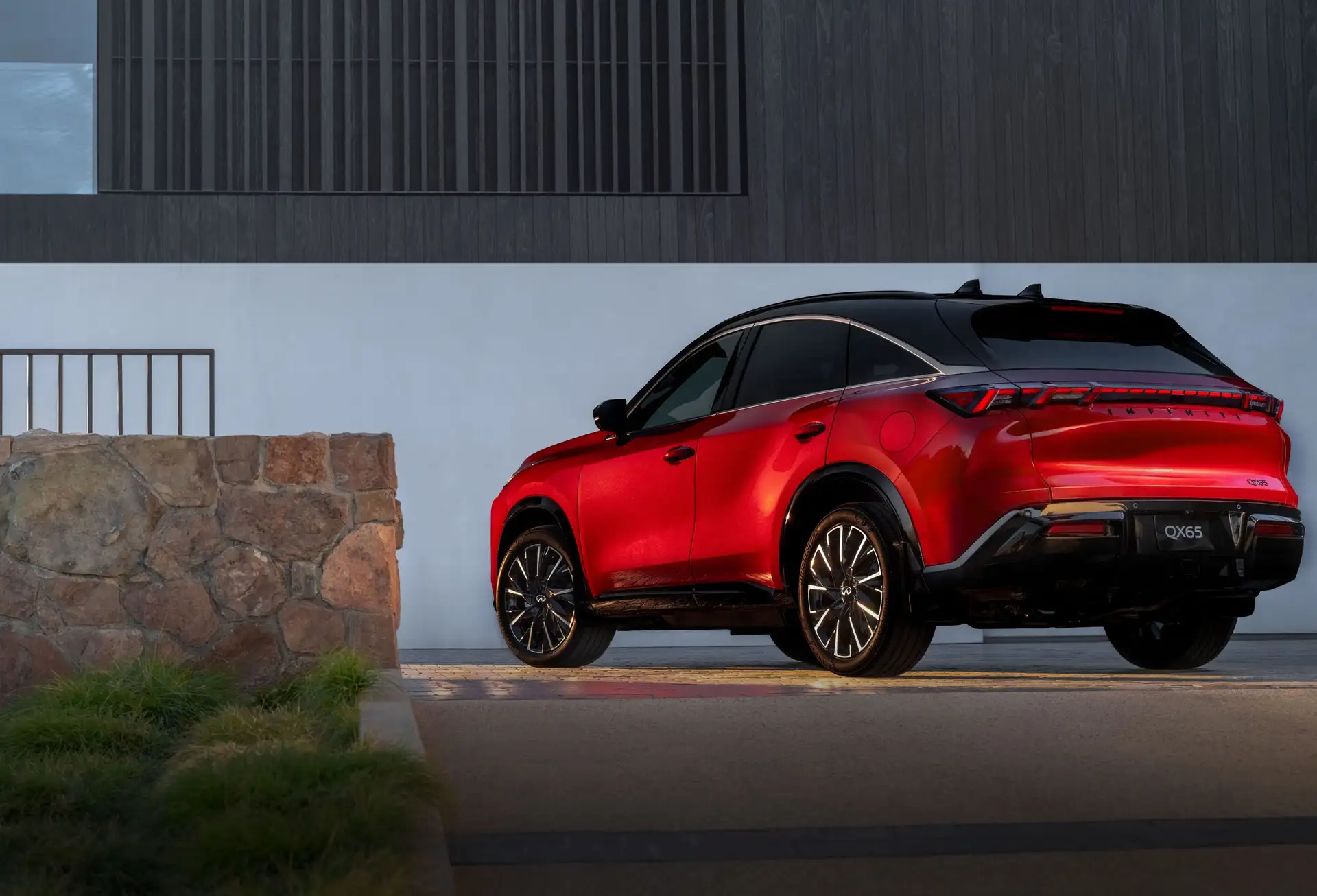 2027 INFINITI QX65 - Vibrant Red SUV Rear Profile With Black Alloys